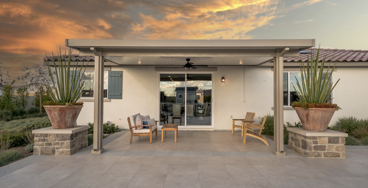 Two-post attached patio cover with Alumabase covers during a beautiful sunset