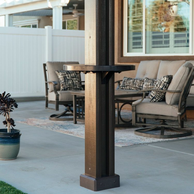 Live product photo of a brown Alumatable installed on a patio cover post of the same color