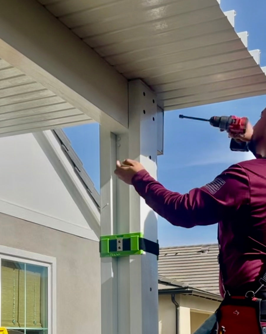 Contractor drilling holes into an alumawood patio cover