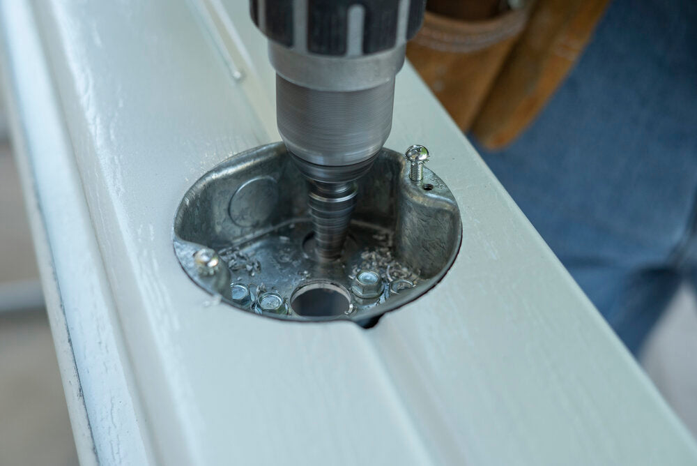 Patio contractor drilling special holes into a patio cover for installation