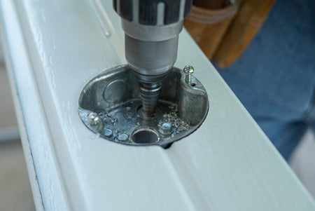 Patio contractor drilling special holes into a patio cover for installation