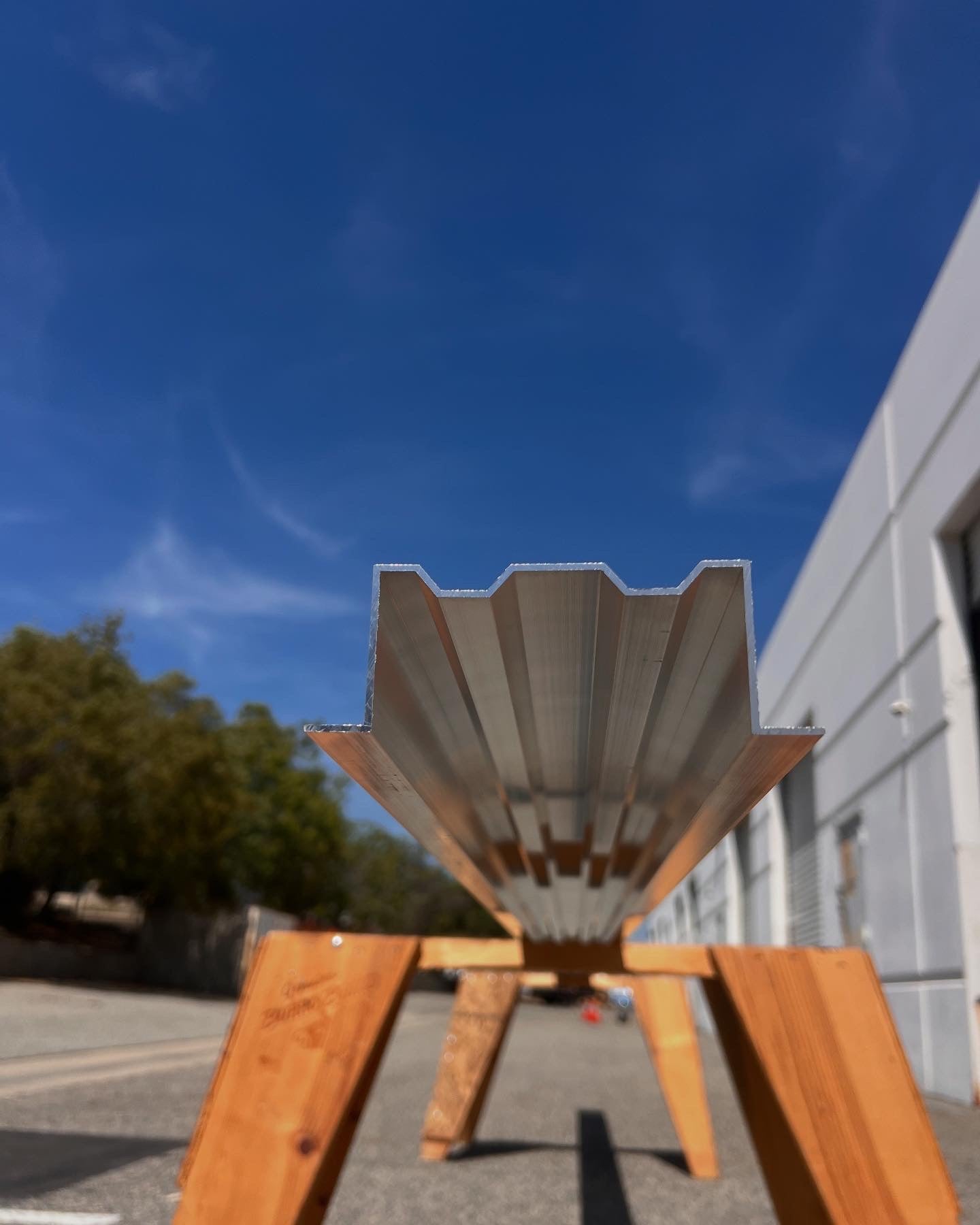 The MegaBeam mounted on a wooden stand outside of a warehouse, being prepared for cutting